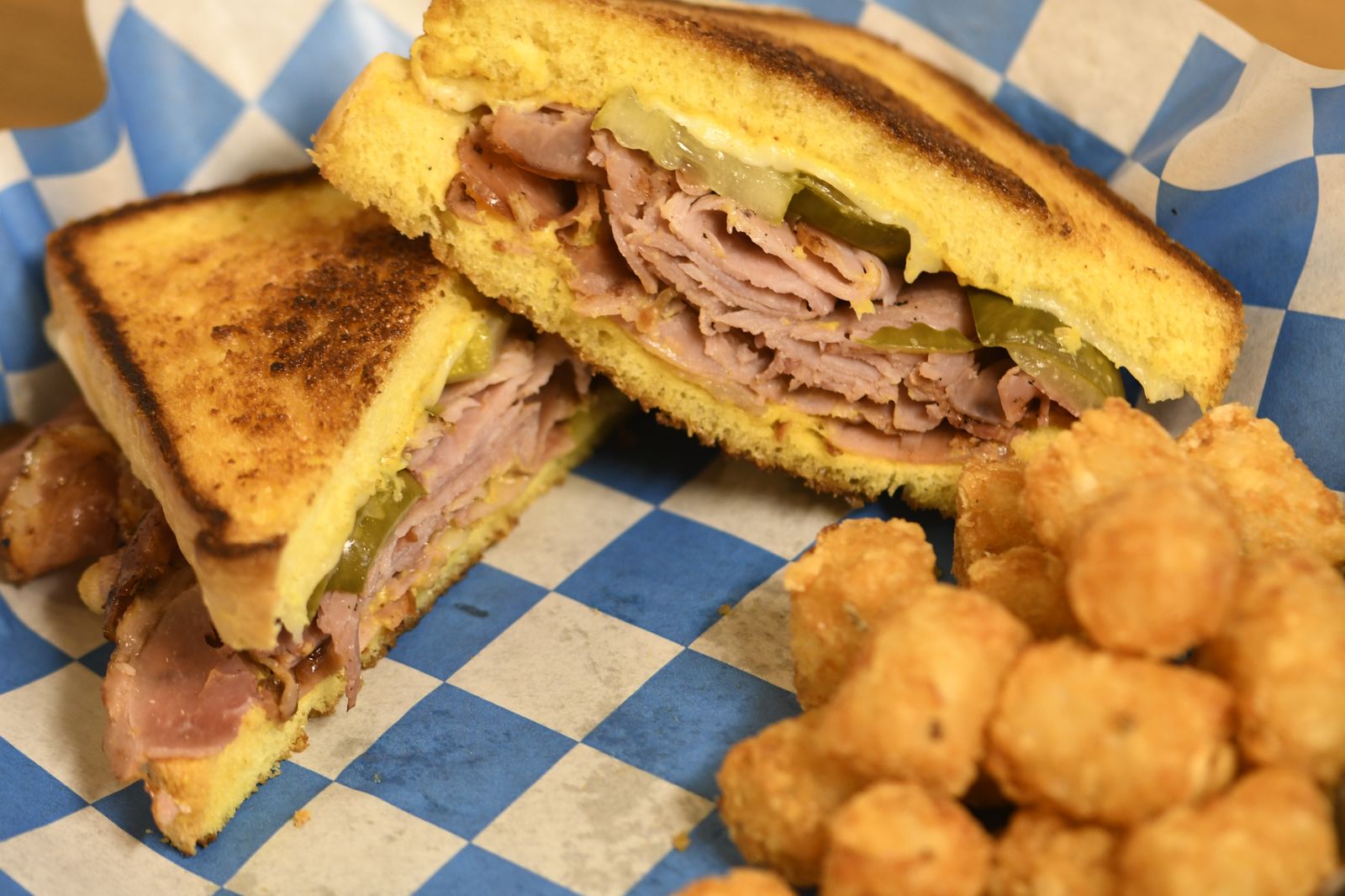 The Cuban — Grilled ham, Swiss, pickles & mustard — with tots